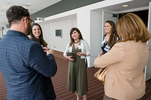 People standing around at a meeting