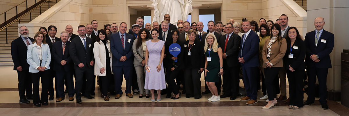 Group of people standing in front of a statue
